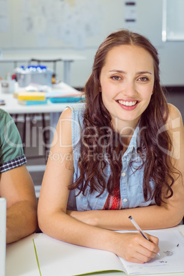 Student taking notes in class