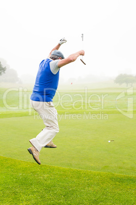 Excited golfer jumping up