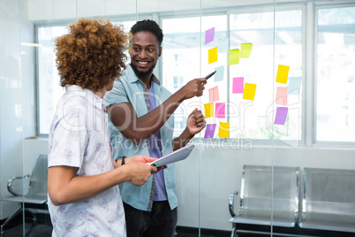 Creative business team pointing at adhesive notes