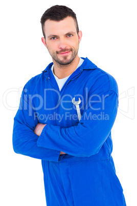 Happy mechanic holding spanner on white background