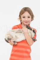 Cute boy holding bunny on white background