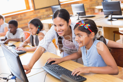 Cute pupils in computer class with teacher