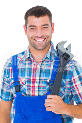 Portrait of confident male repairman holding adjustable wrench