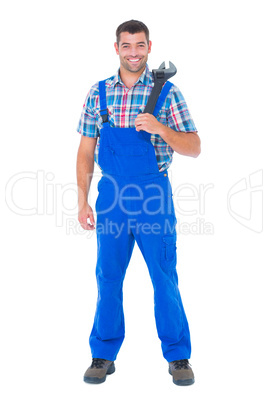 Confident male repairman holding adjustable wrench