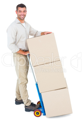 Happy delivery man with trolley of boxes Happy delivery man with trolley of boxes