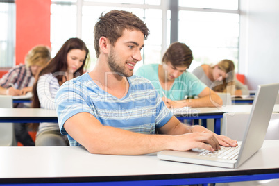 Student using laptop in classroom