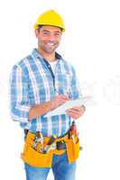 Portrait of smiling handyman writing on clipboard
