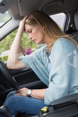Worried woman sitting in drivers seat