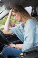Worried woman sitting in drivers seat