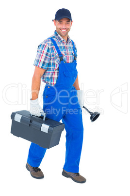 Happy plumber with plunger and toolbox walking on white backgrou