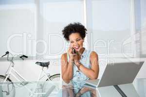Young casual woman using cellphone