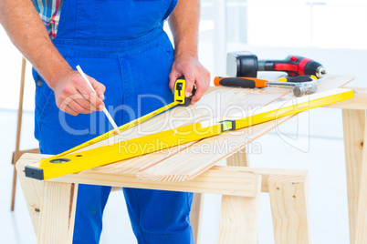 Carpenter working at workbench in office