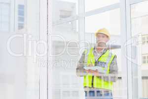 Supervisor writing on clipboard in office