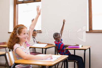 Pupils raising their hands during class