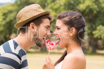 Cute couple sharing a lollipop