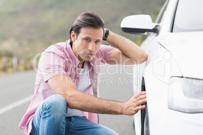 Stressed man looking at wheel Stressed man looking at wheel