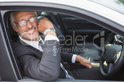 Handsome businessman looking at camera