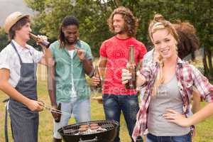 Happy friends in the park having barbecue