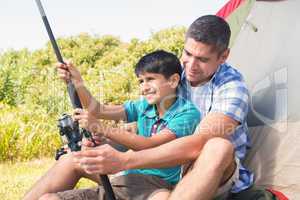 Father and son beside tent