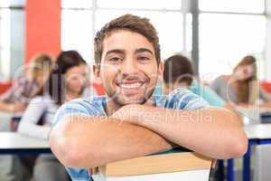 Smiling male student in classroom