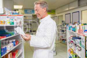 Senior pharmacist reading prescription