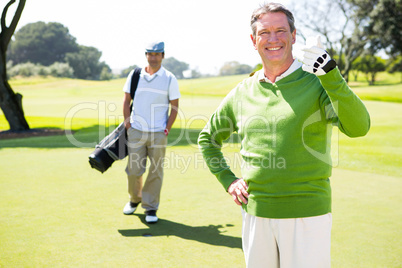 Golfing friends smiling at camera