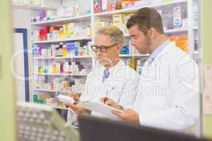 Team of pharmacists writing on clipboard