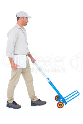 Delivery man pushing empty trolley on white background