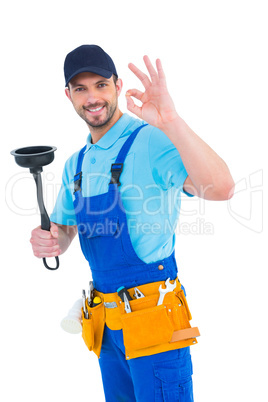 Plumber with plunger gesturing okay