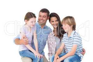 Children sitting on parents laps over white background