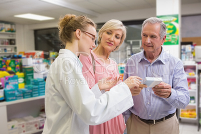 Pharmacist and her customers talking about medication