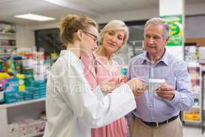 Pharmacist and her customers talking about medication