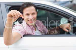 Man smiling at camera showing key