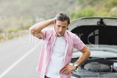 Stressed man waiting assistance after a car breakdown