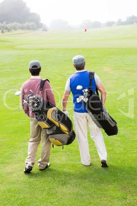 Golfer friends walking and chatting