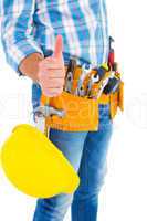 Midsection of manual worker gesturing thumbs up