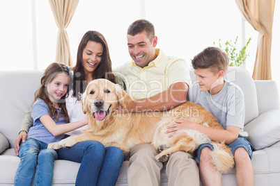 Family of stroking Golden Retriever