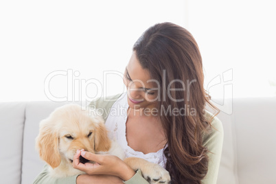 Happy woman playing with puppy