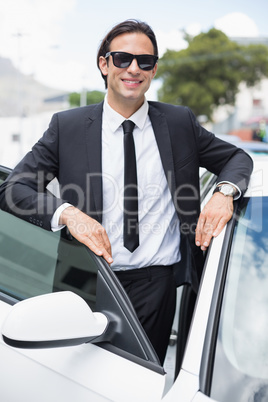 Businessman leaning on the door