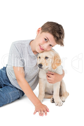 Happy boy embracing puppy