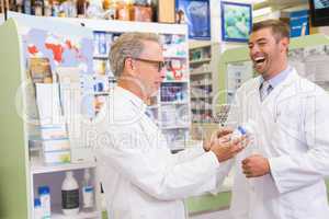 Smiling pharmacists holding medication