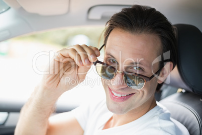 Man driving and smiling at camera