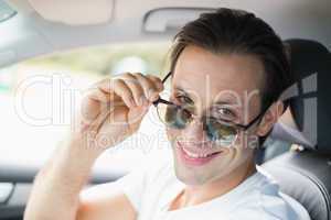 Man driving and smiling at camera