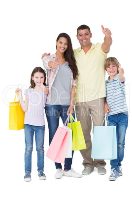 Family with shopping bags gesturing thumbs up