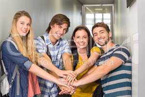 College students placing hands together