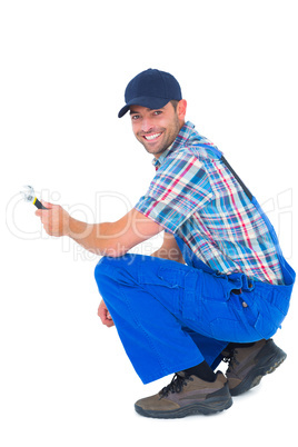 Portrait of happy handyman holding wrench