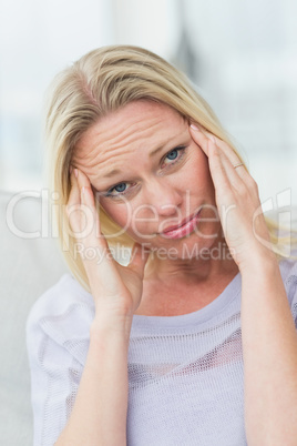 Portrait of upset woman rubbing her temples