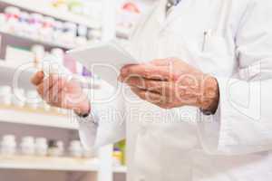 Pharmacist looking at prescription and medicine