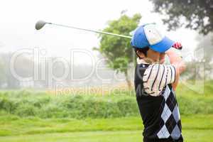 Golfer teeing off