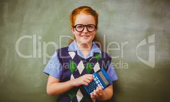 Portrait of cute little girl holding calculator